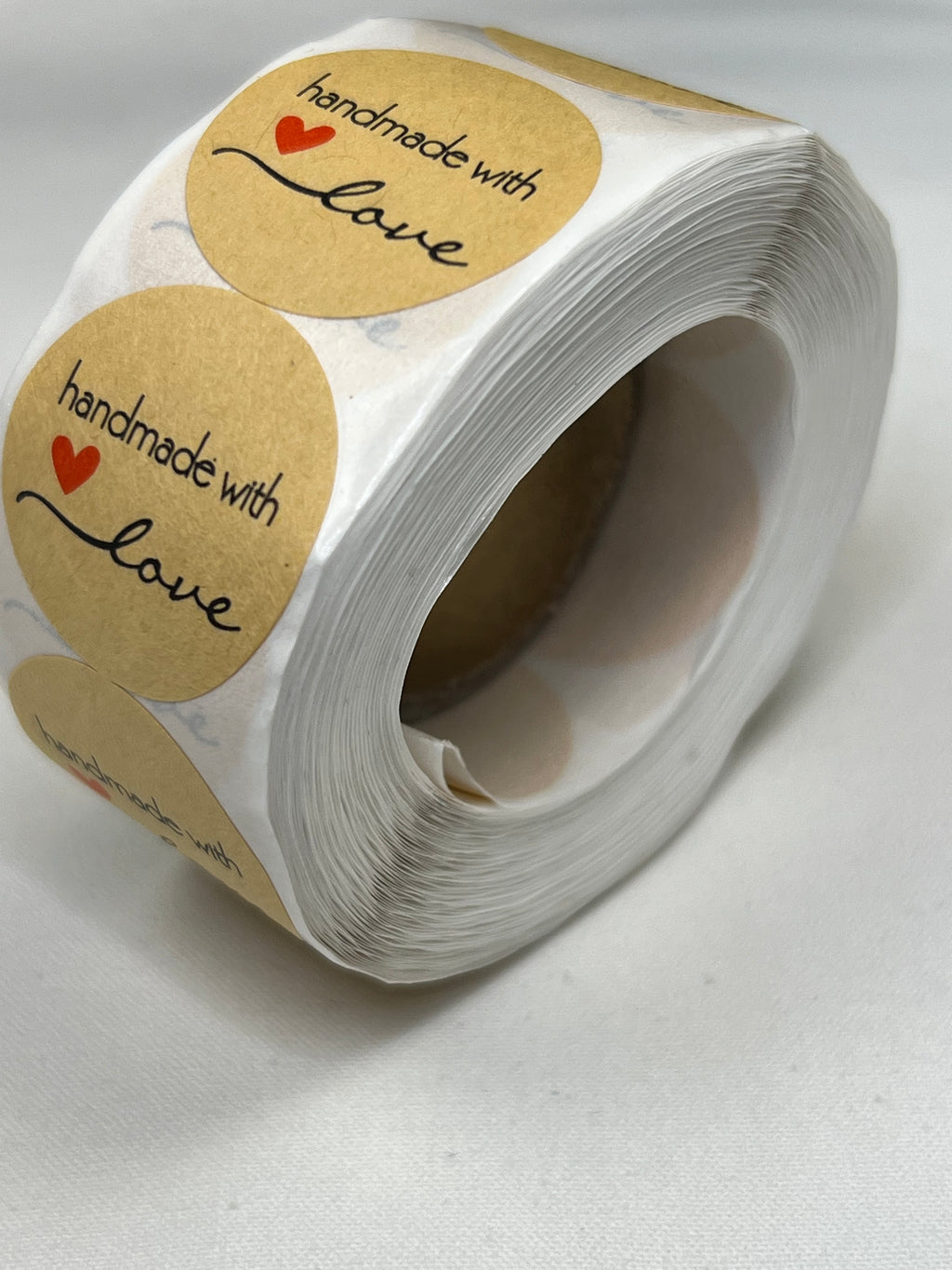 Roll of 1-inch kraft paper stickers with "handmade with love" text and a red heart.