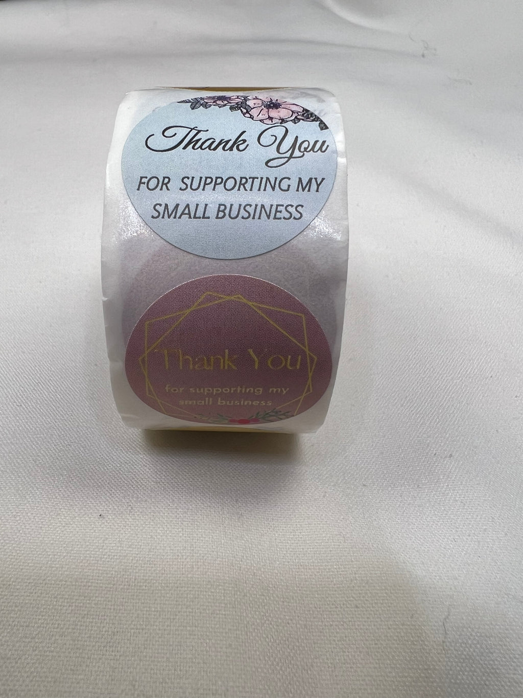 A roll of 1-inch "Thank You for Supporting My Small Business" stickers with floral and geometric designs.