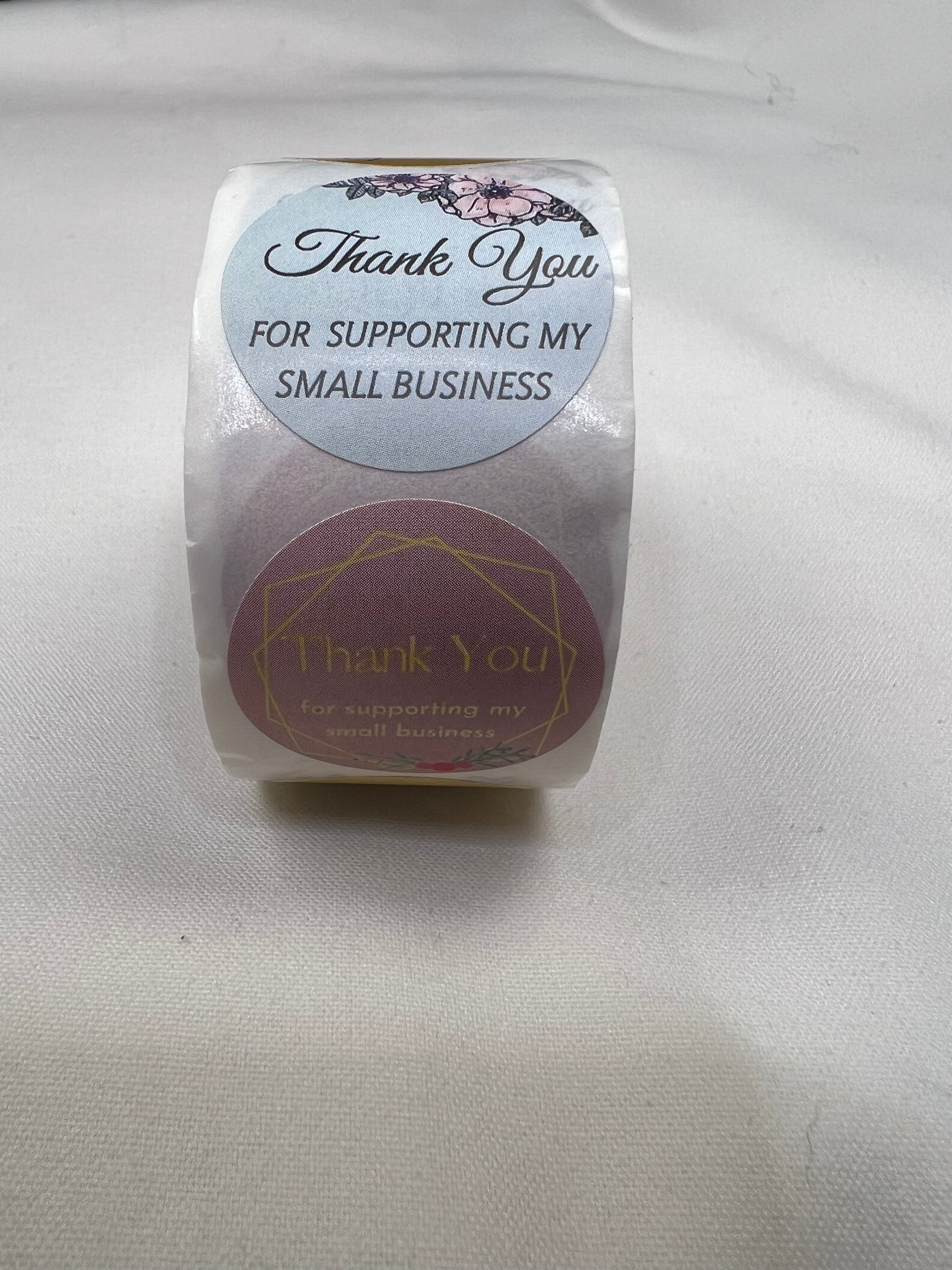 A roll of 1-inch "Thank You for Supporting My Small Business" stickers with floral and geometric designs.