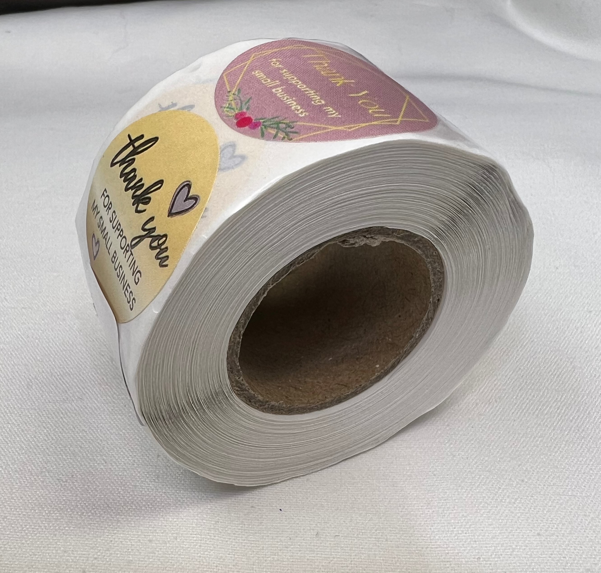 A roll of 1-inch "Thank You for Your Business" stickers with three different patterns.