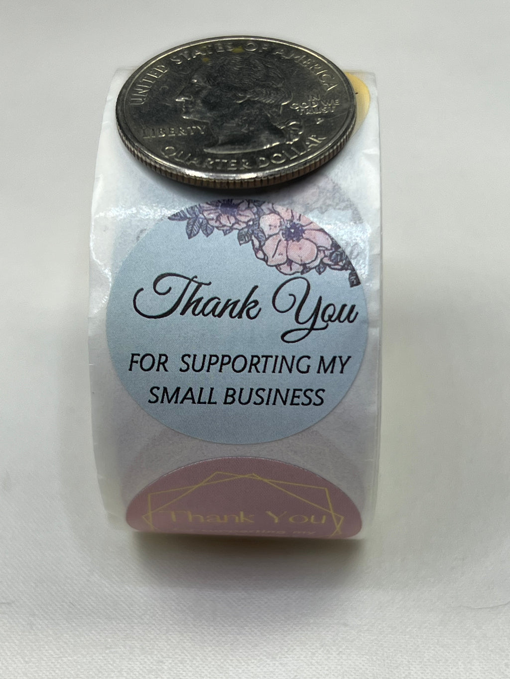 A roll of 1-inch "Thank You for Your Business" stickers with floral and geometric patterns.