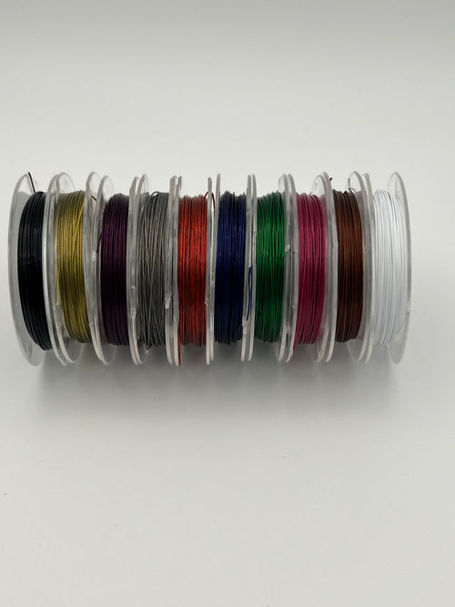 Ten spools of colorful, thin tiger tail wire for jewelry making.