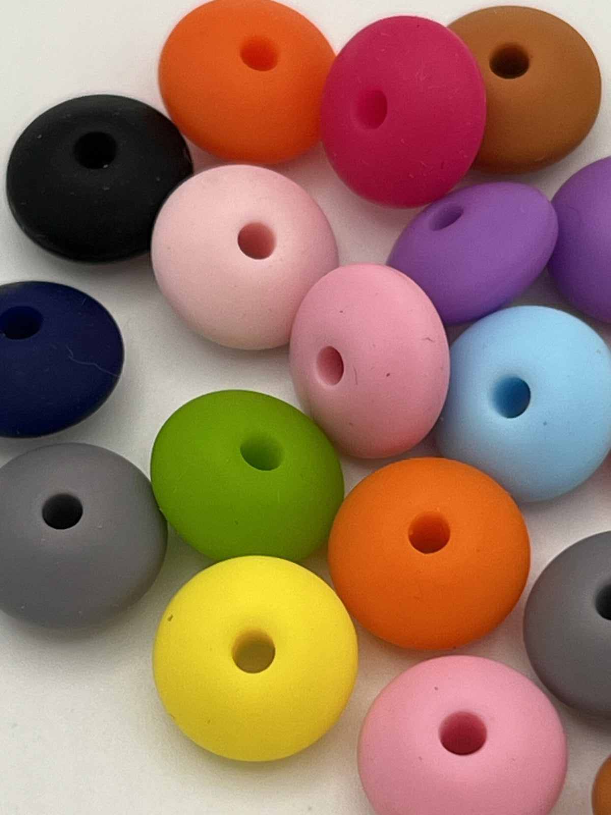 Assorted 12mm silicone abacus beads in various colors including pink, orange, blue, and green.