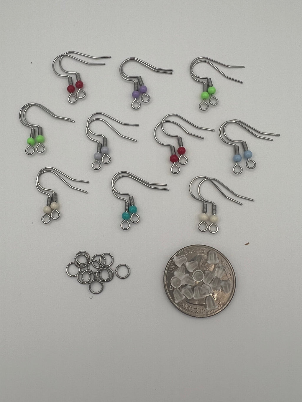 304 stainless steel ear wires with acrylic beads, silicone nuts, and jump rings.