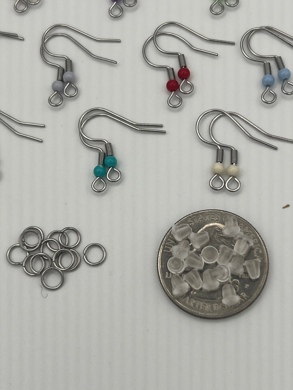 Stainless steel ear wires with acrylic beads, silicone nuts, and jump rings.