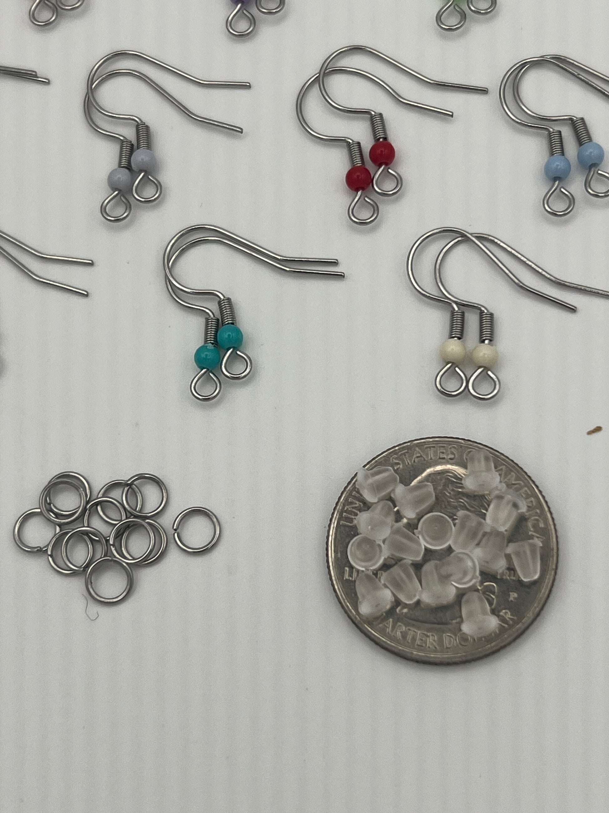 Stainless steel ear wires with acrylic beads, silicone nuts, and jump rings.