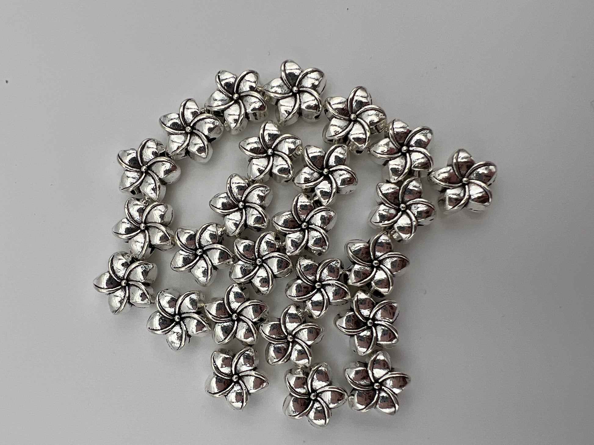 25 antique silver Tibetan style plumeria flower beads.