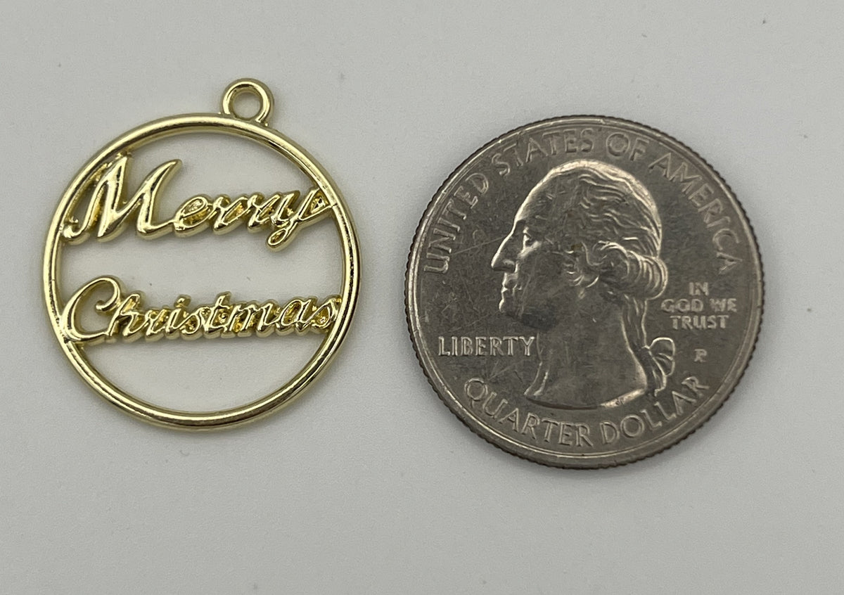Golden round Merry Christmas pendant next to a US quarter for scale.