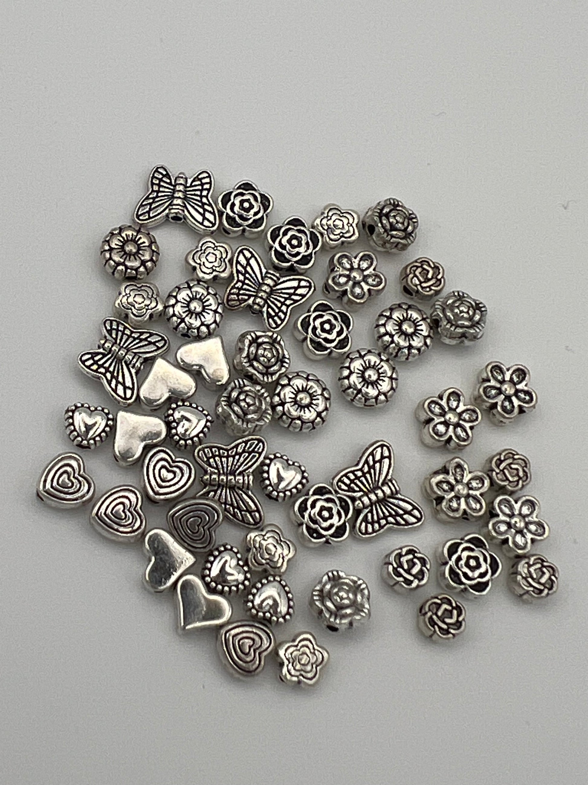 Tibetan style antique silver beads featuring butterflies, hearts, and flowers in 10 designs.