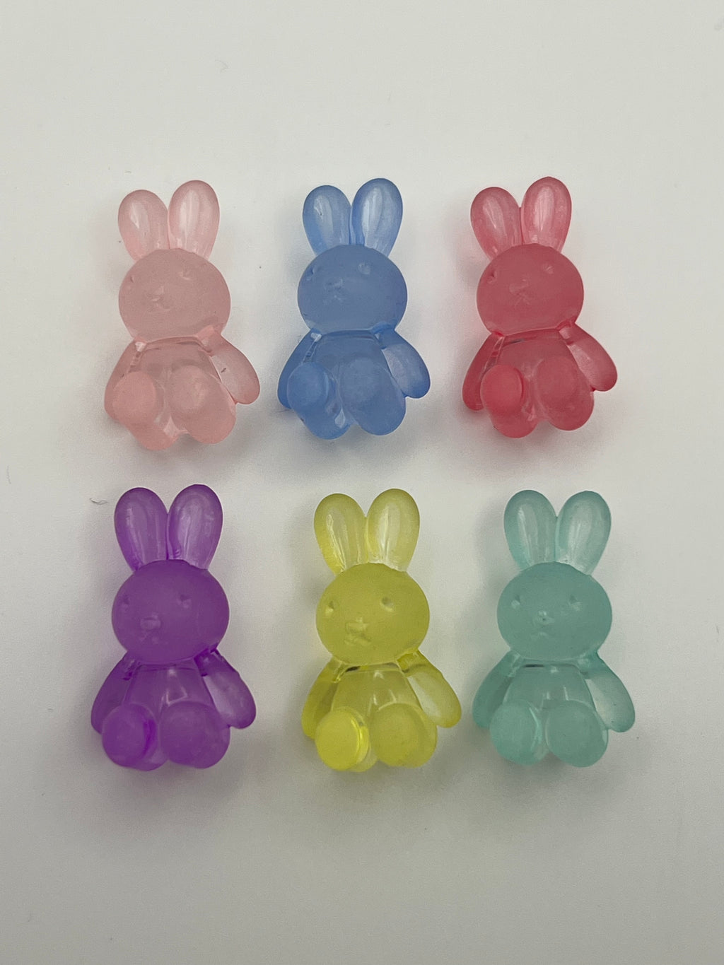 Frosted acrylic bunny beads in pink, blue, red, purple, yellow, and teal.