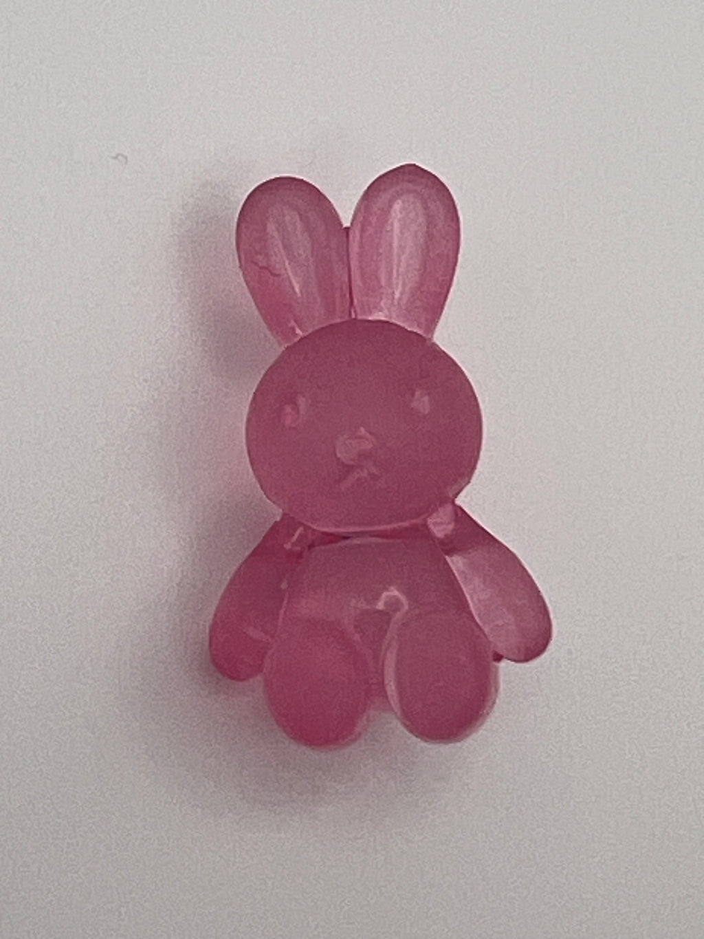 Frosted acrylic bunny beads in pink with a hole for crafting.