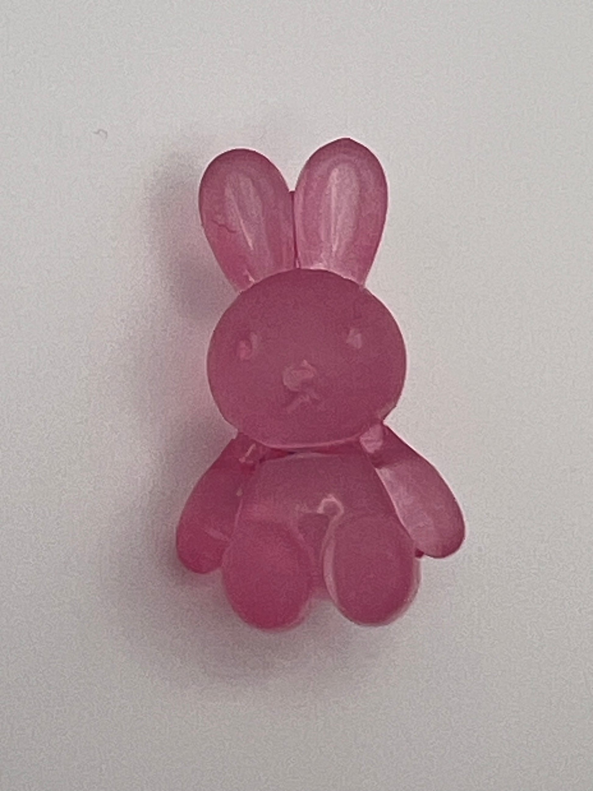 Frosted acrylic bunny beads in pink with a hole for crafting.