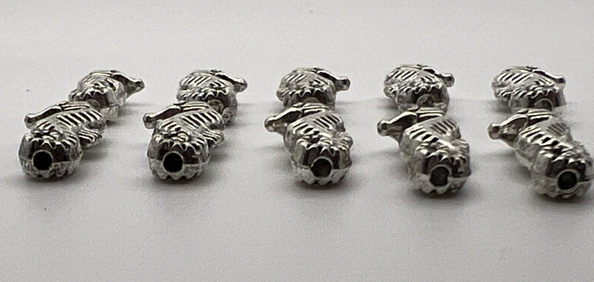 Antique silver seahorse beads with a Tibetan style design.