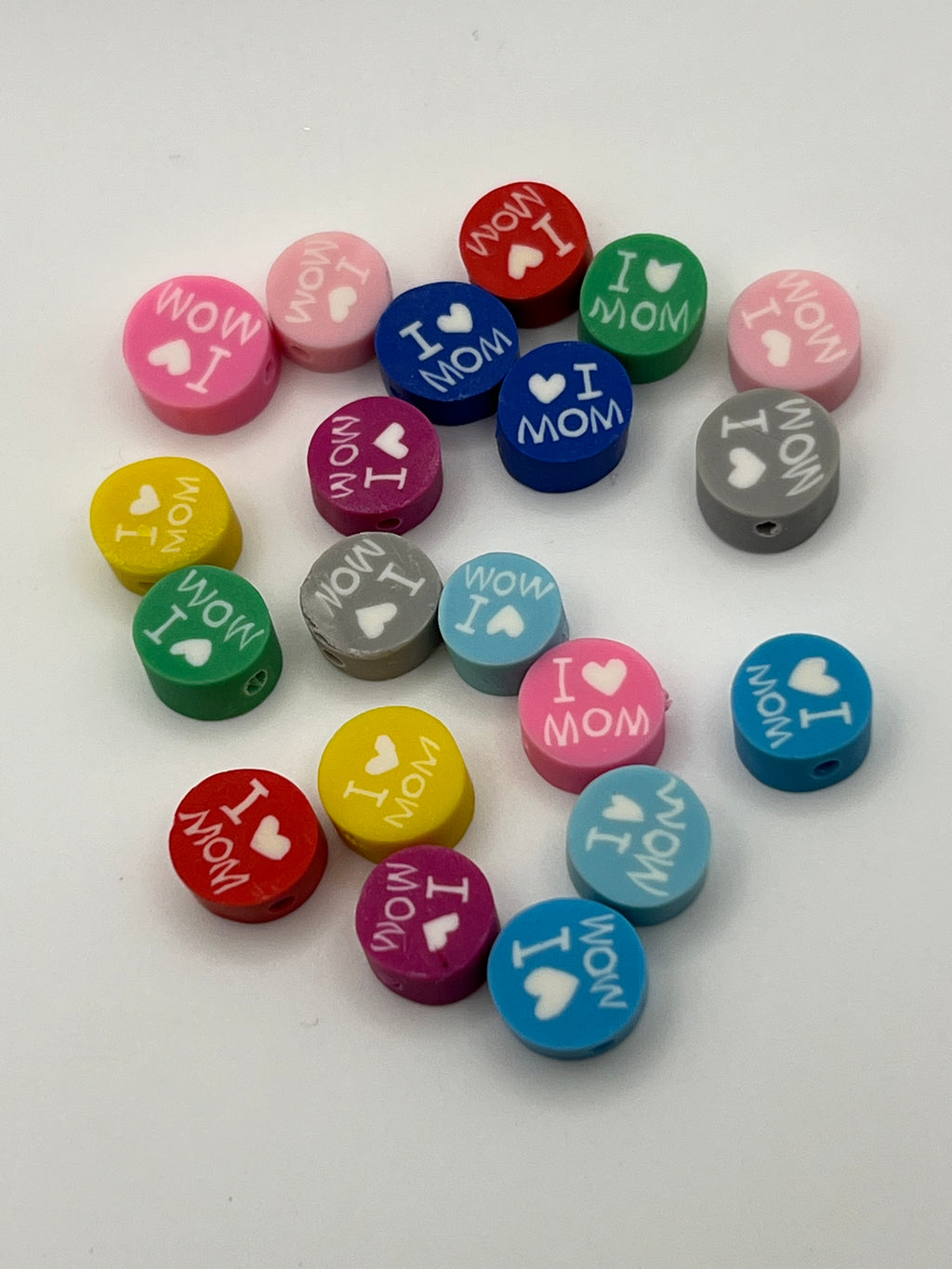 A set of 20 colorful polymer clay beads with "I Love Mom" and heart designs.