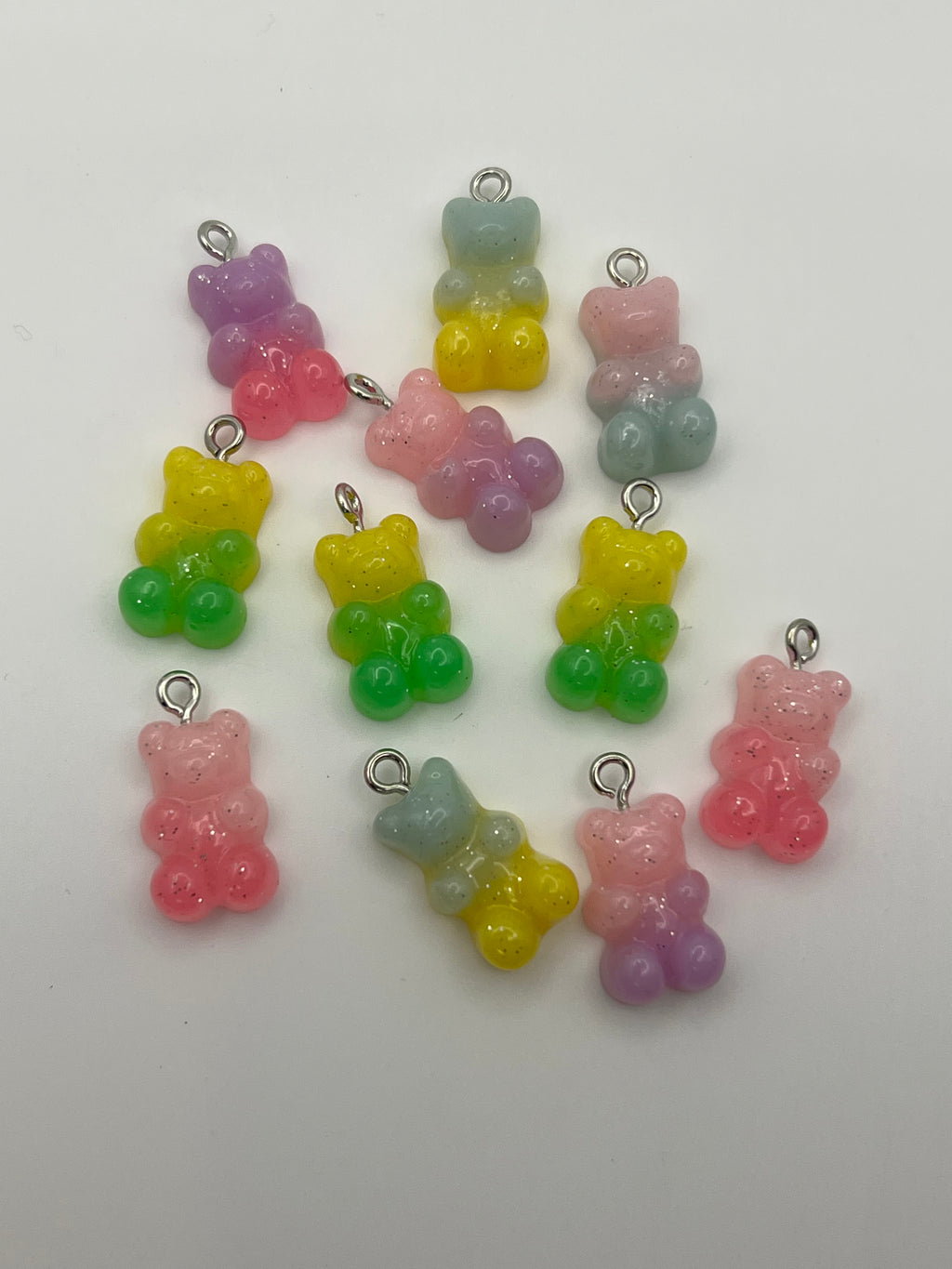 Ten resin gummy bear charms in mixed gradient colors with silver loops.