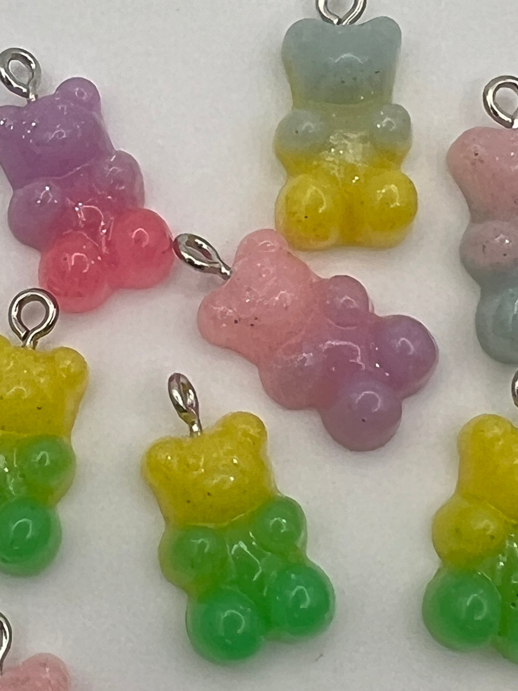 Resin gummy bear pendants in mixed gradient colors with silver loops.