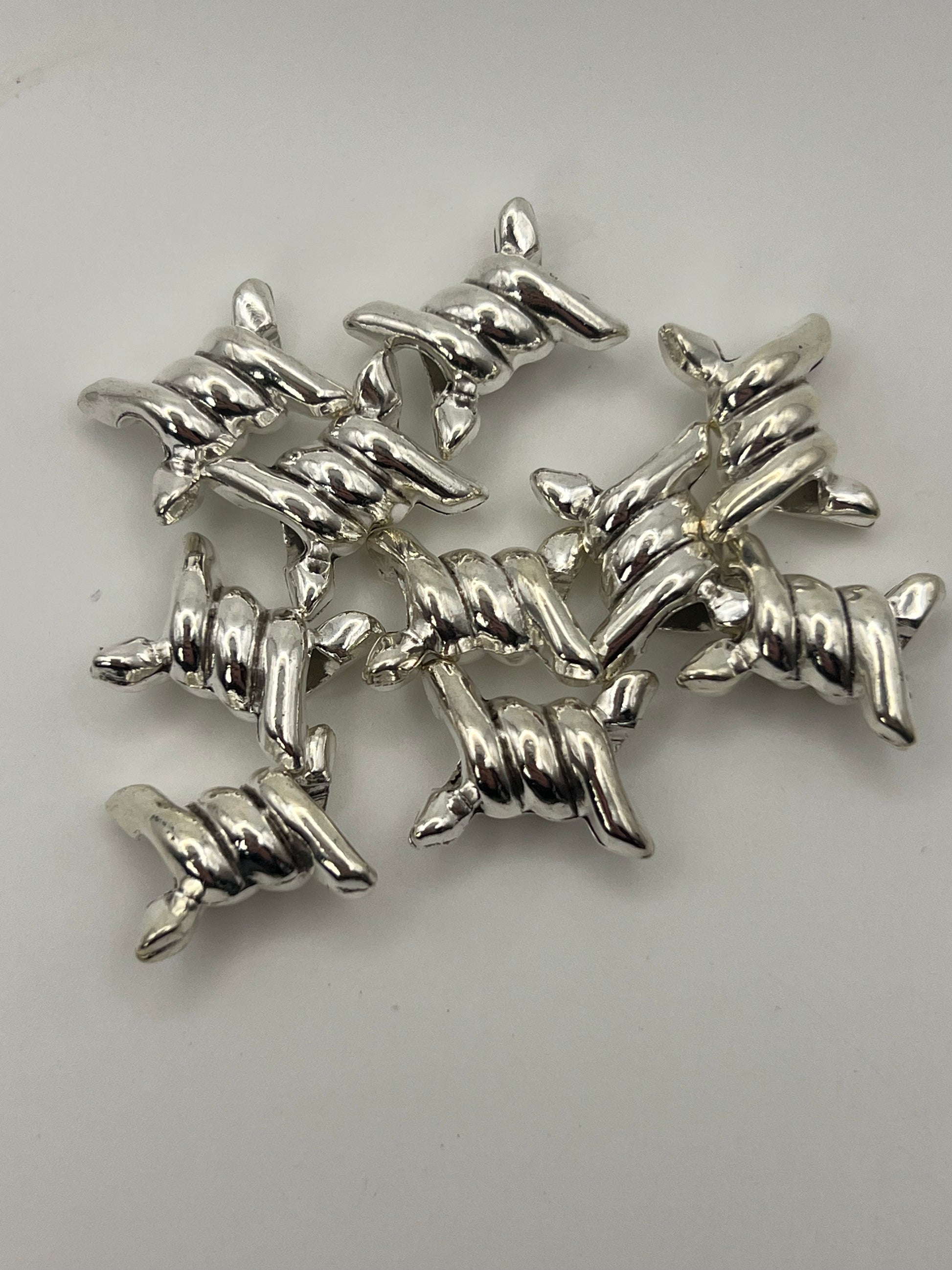 Silver-tone barbed wire European beads with a 4.5mm hole.