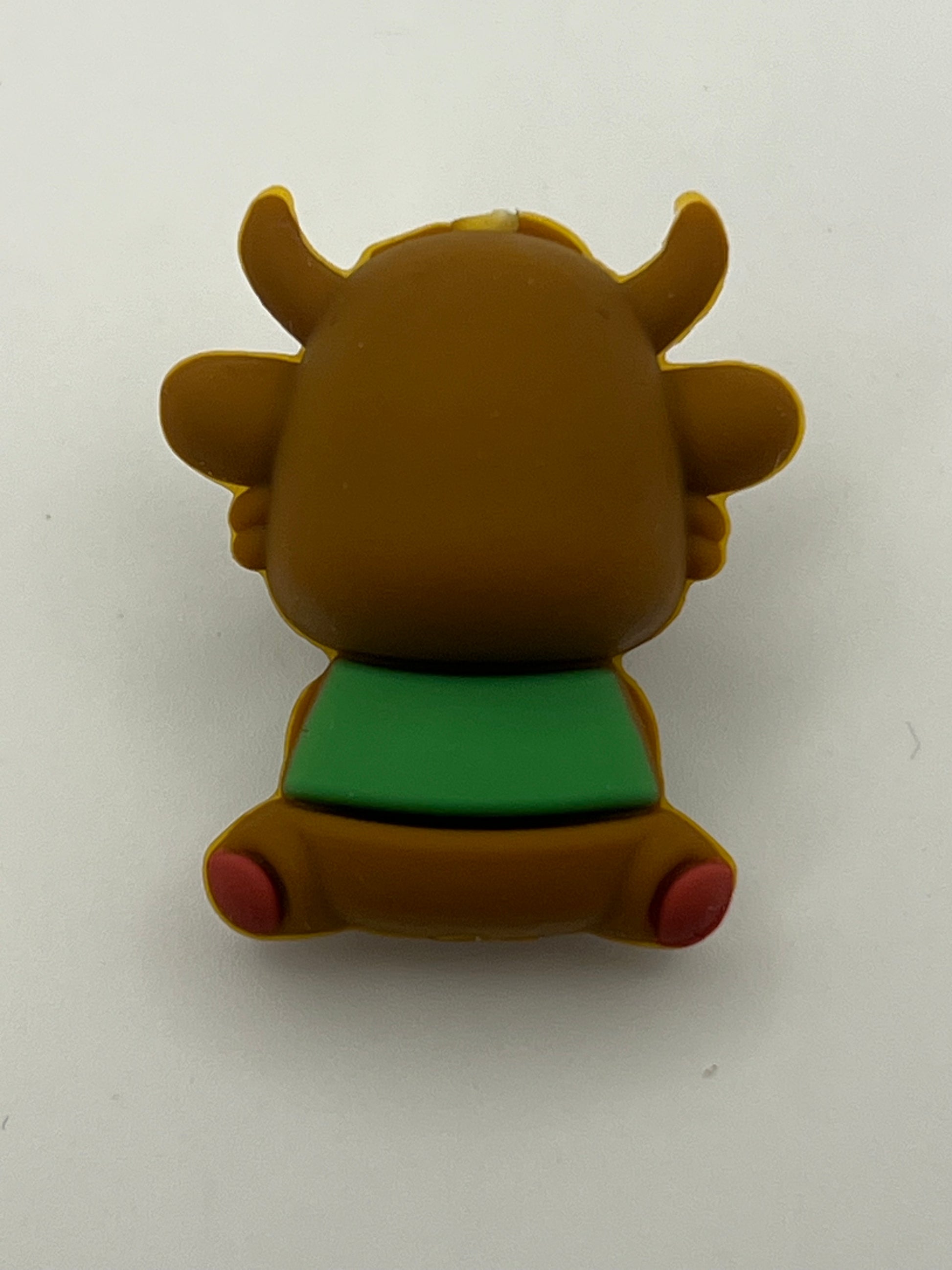 Brown silicone clover cow focal bead with green shirt and red feet.