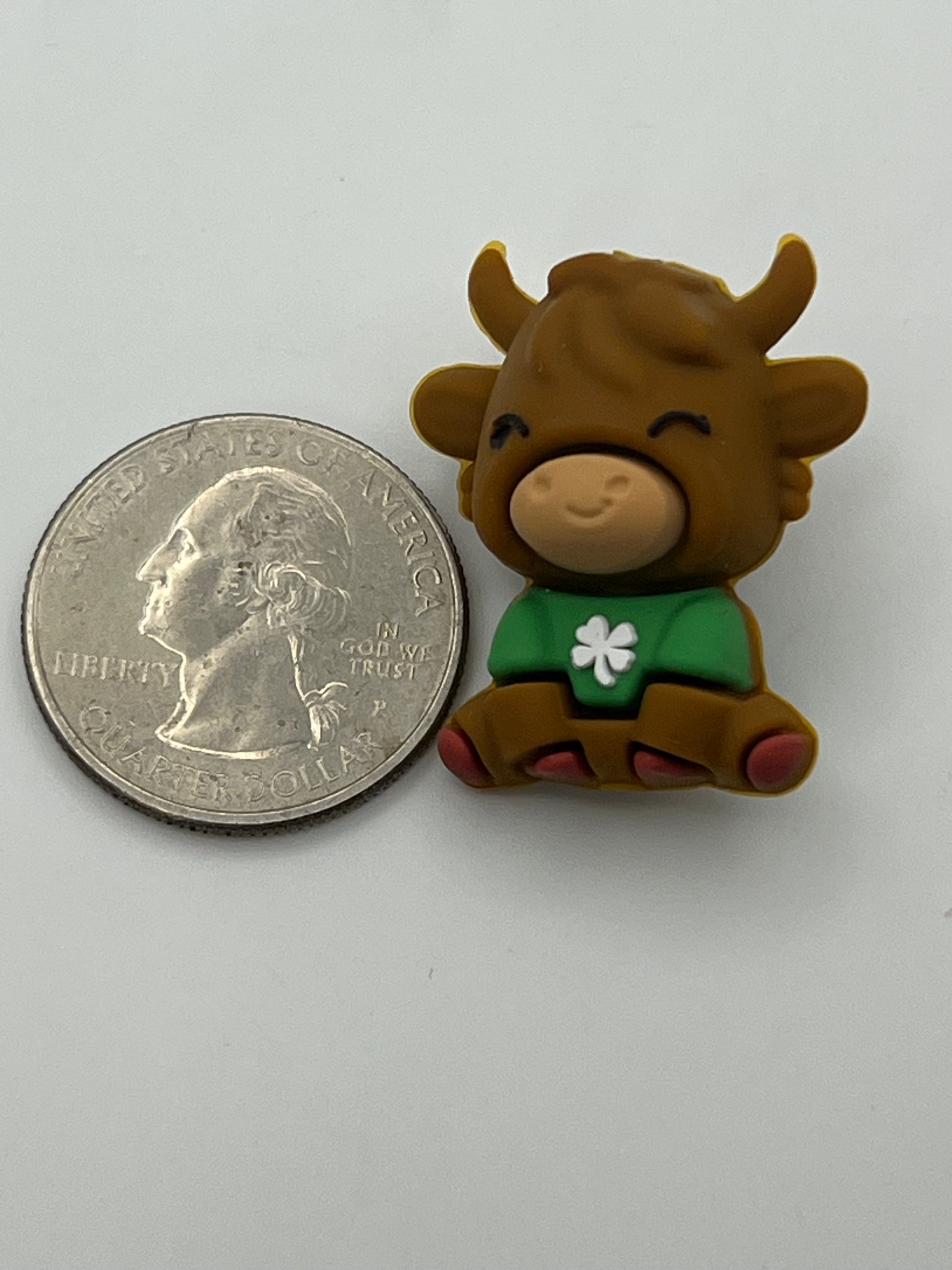 Silicone focal bead of a cow wearing a green shirt with a clover.