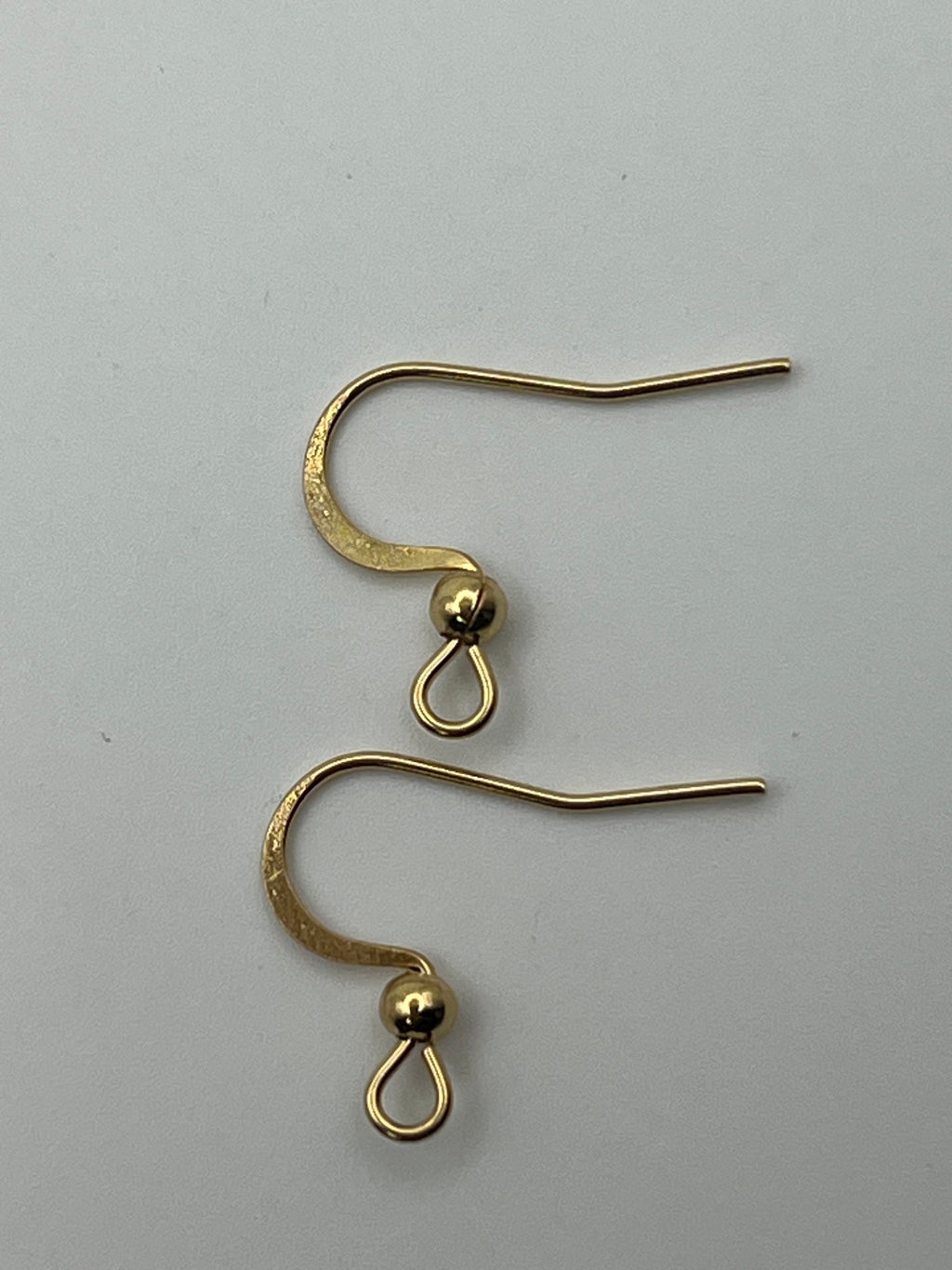 Two gold-plated stainless steel earring hooks with horizontal loops.