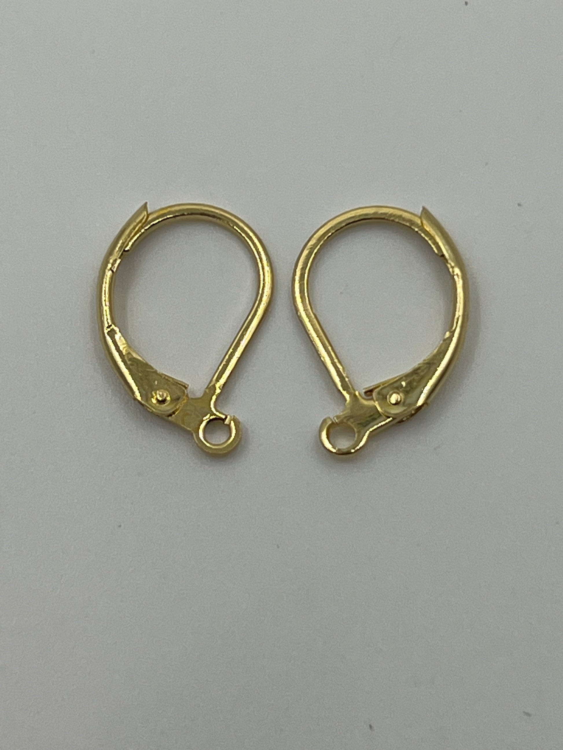 Two gold-plated leverback earring hooks on a white background.
