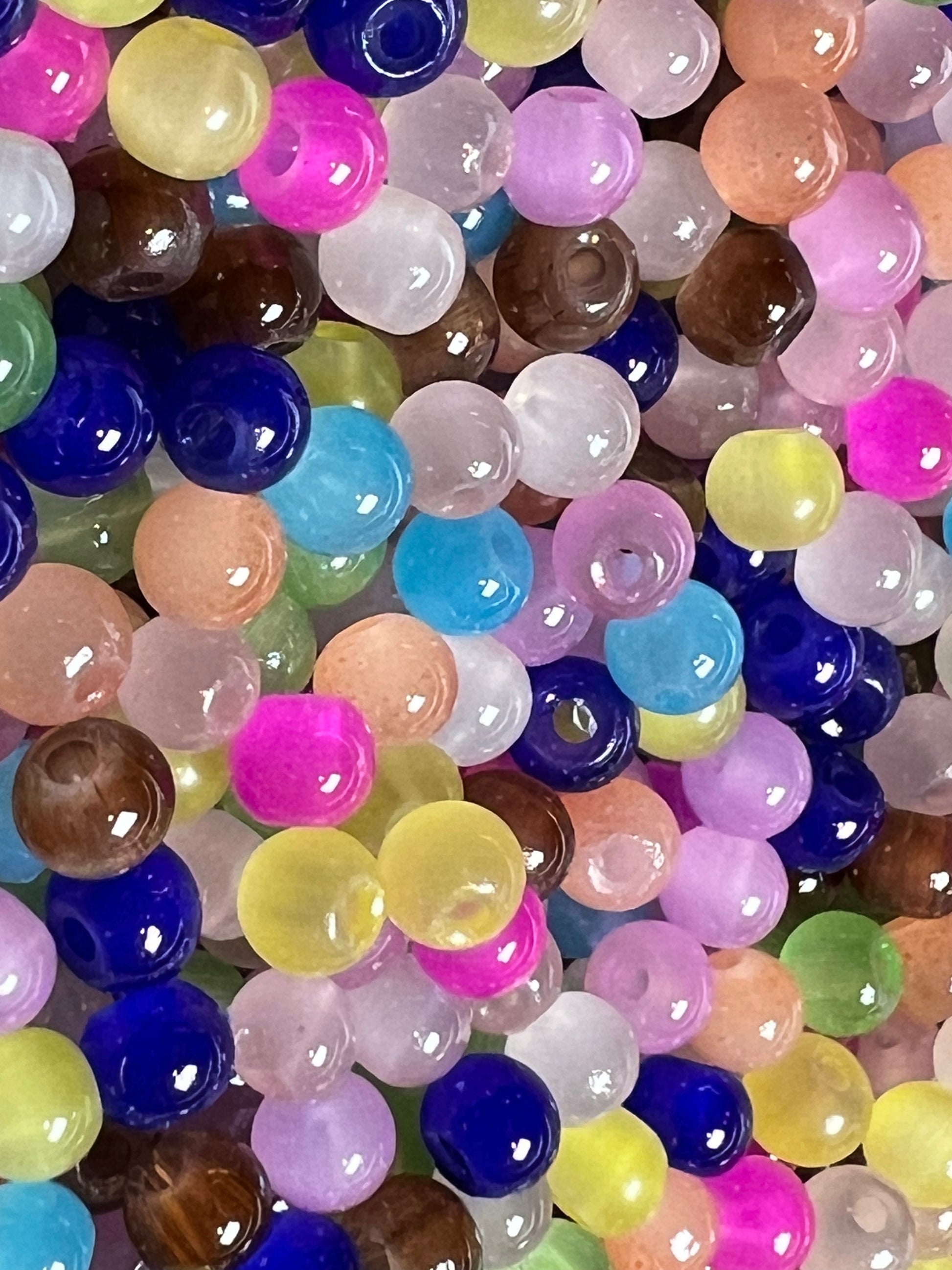 A collection of small, round, multicolored glass imitation jade beads.