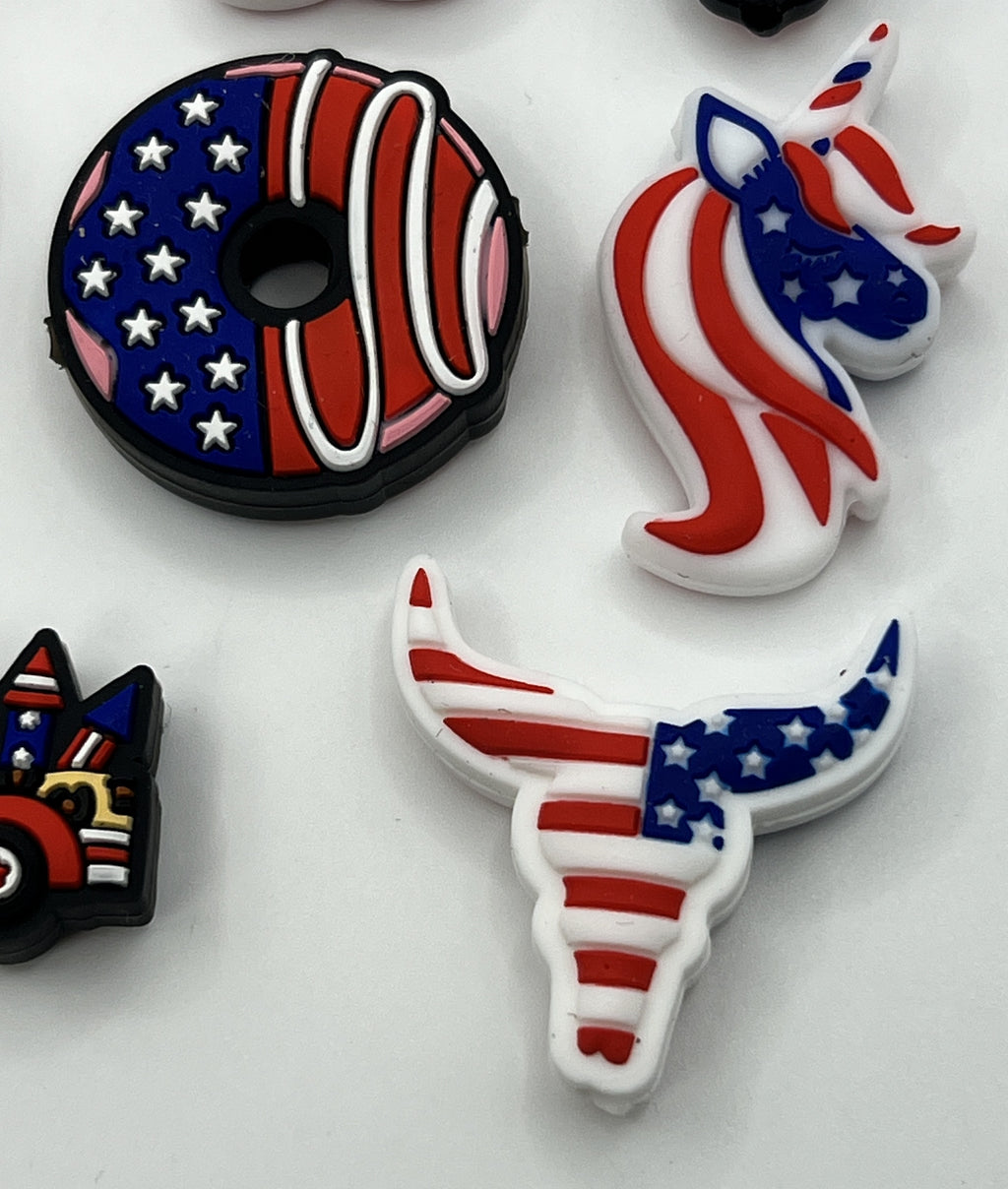 A set of patriotic silicone focal beads featuring a donut, unicorn, and bull skull design.