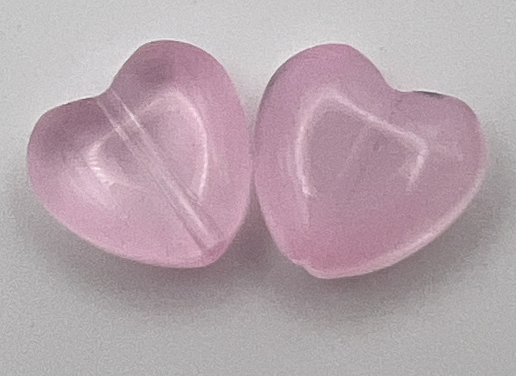 Two 12mm heart-shaped beads in a translucent pearl pink glass finish.