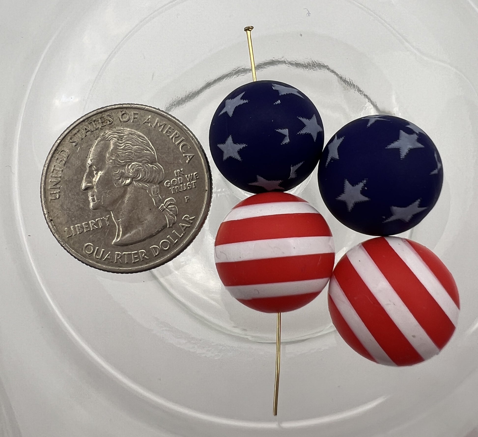 Four 15mm Americana silicone beads with star and stripe patterns shown next to a US quarter.