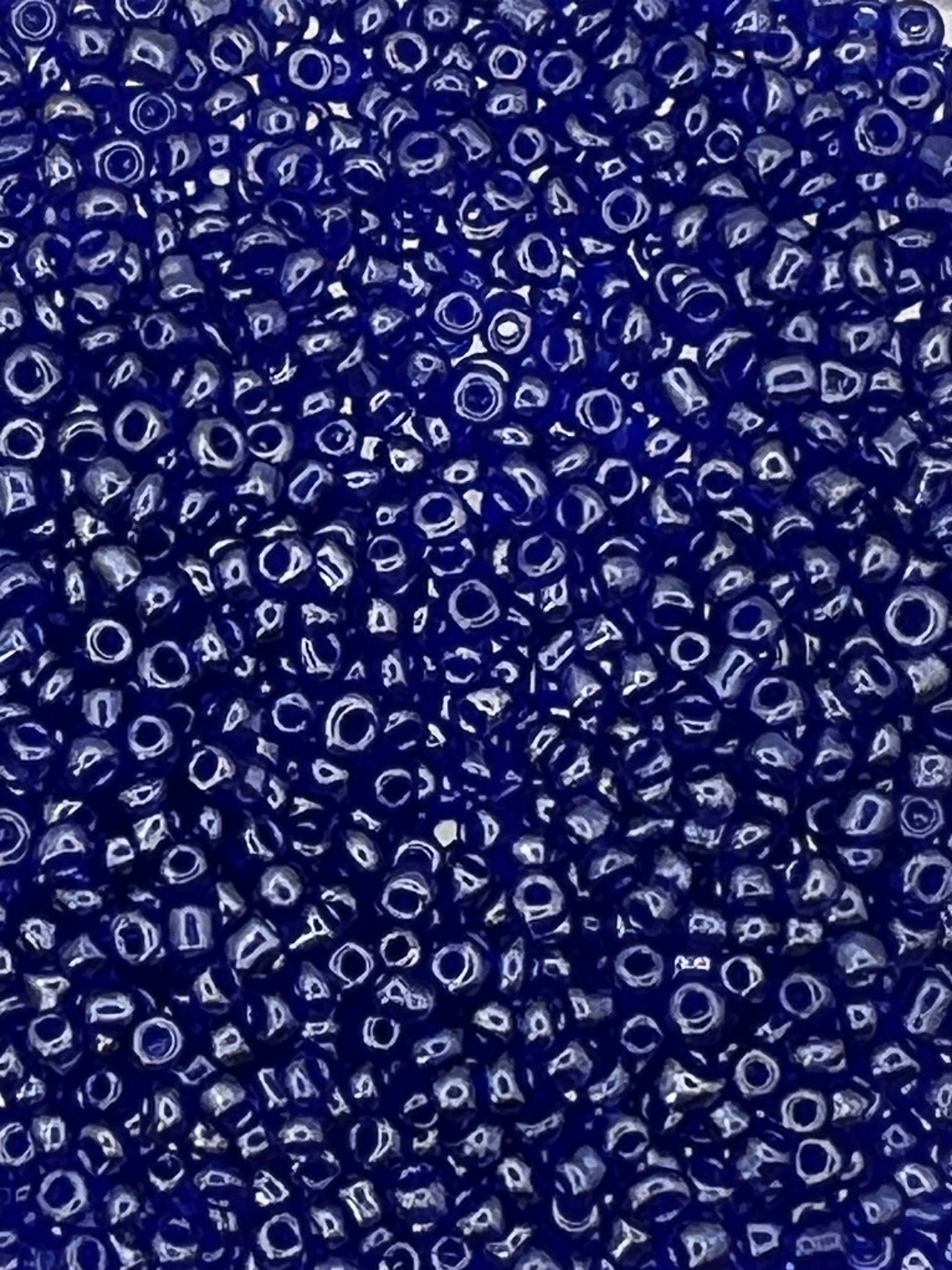 Close-up of 1 oz. 12/0 transparent lustered blue glass seed beads.