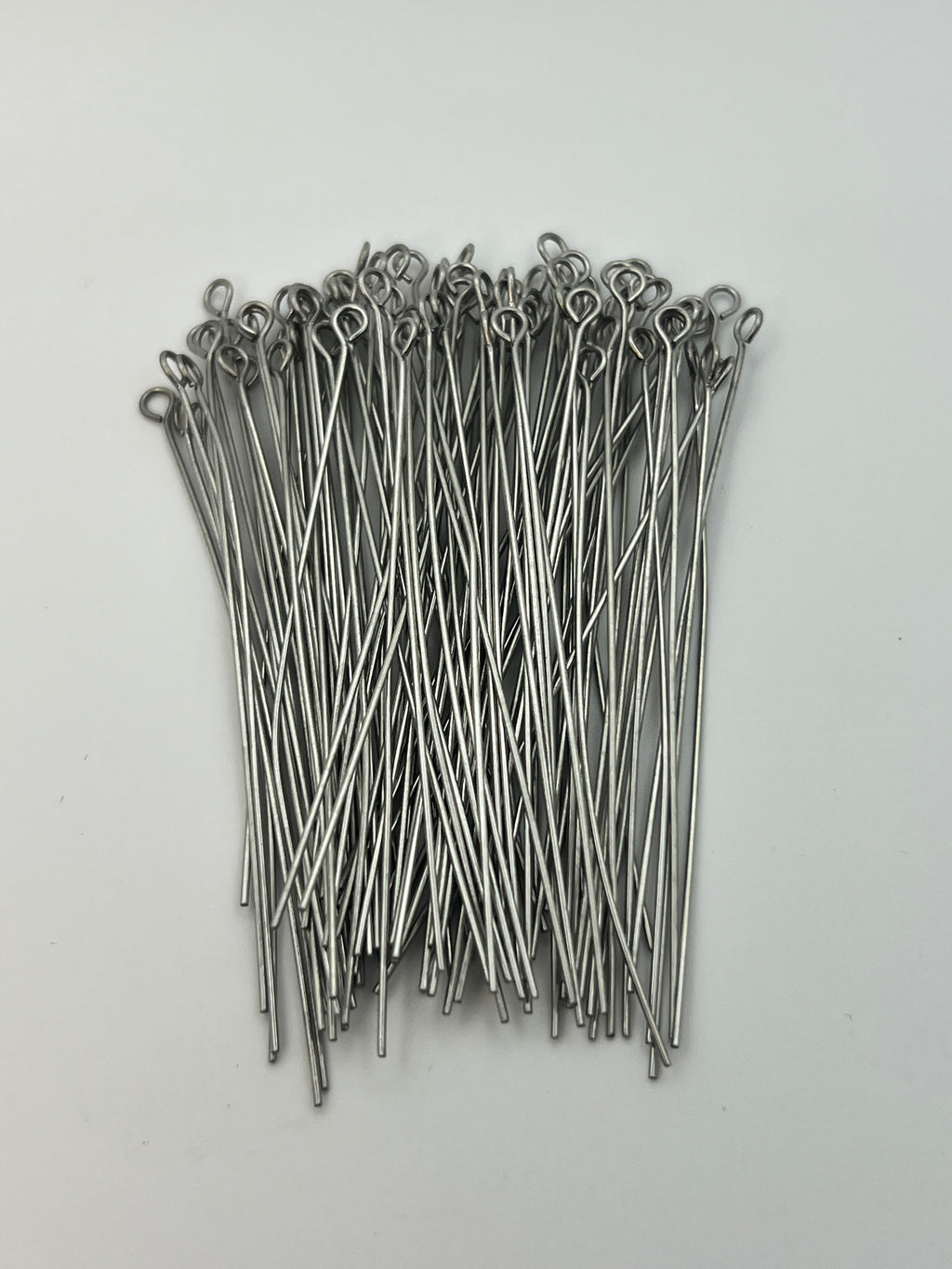 A bundle of 65mm 304 stainless steel eye pins with looped ends on a white background.