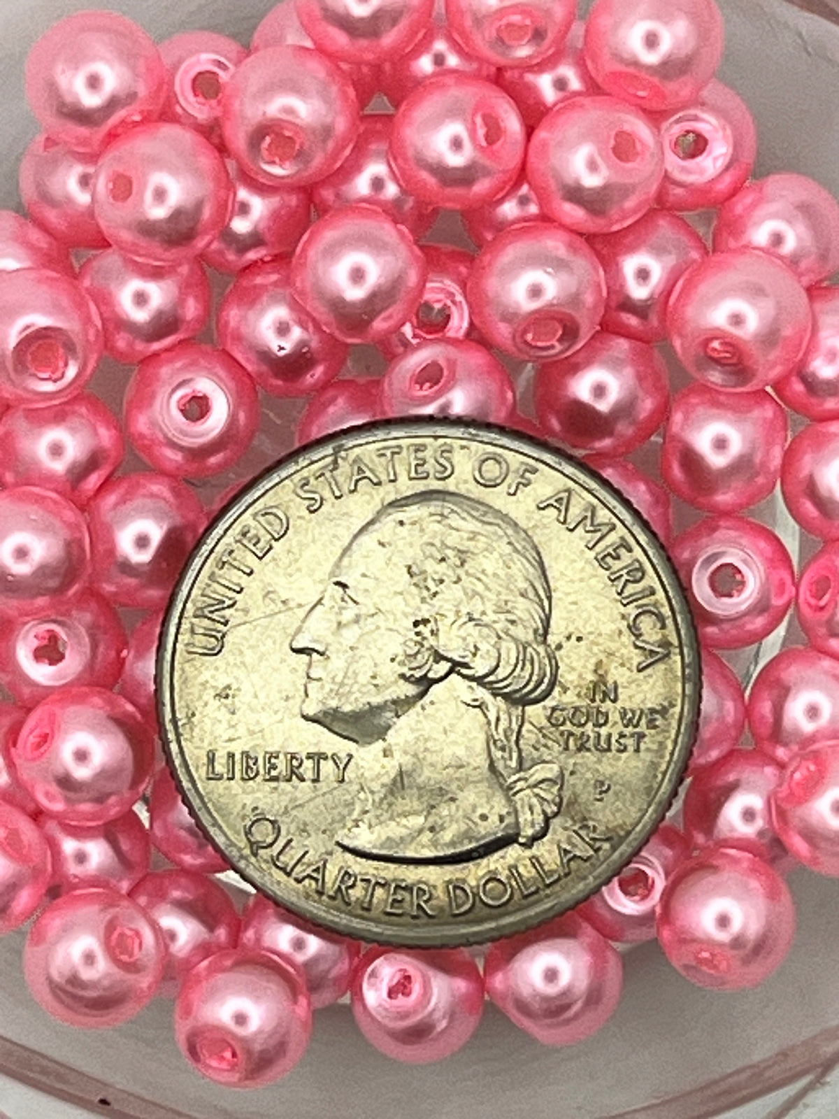 6mm hot pink glass pearl beads shown next to a US quarter for scale.