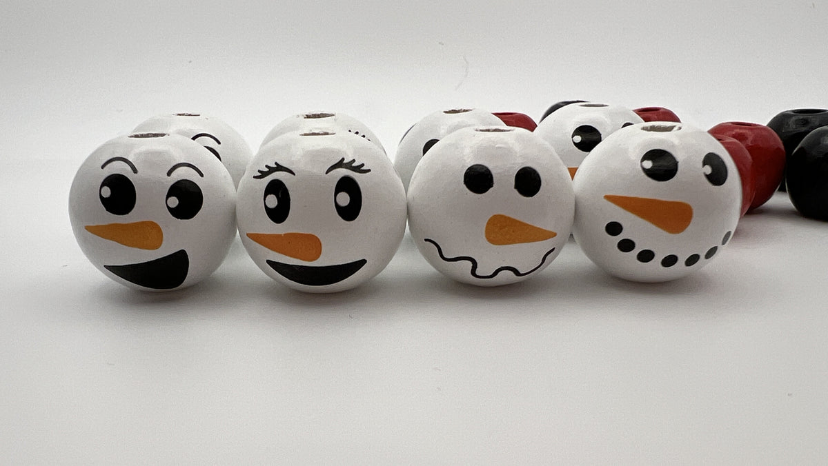 Set of 18 Christmas wood beads featuring four different snowman face designs and solid accents.