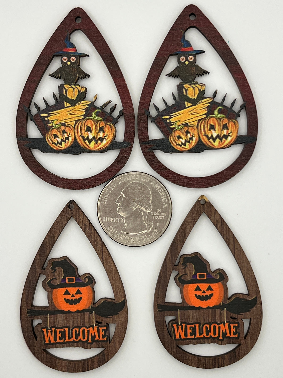 Four teardrop-shaped wooden Halloween pendants featuring owls, pumpkins, and a welcome sign.
