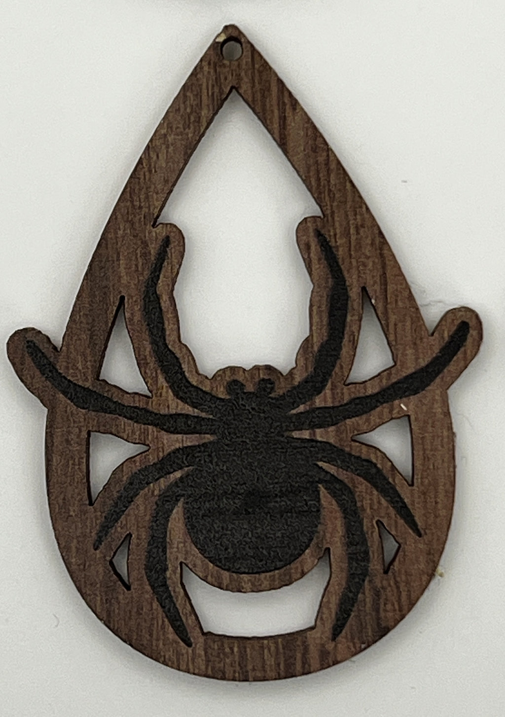 Teardrop-shaped wooden pendant with a laser-cut and printed black spider design.