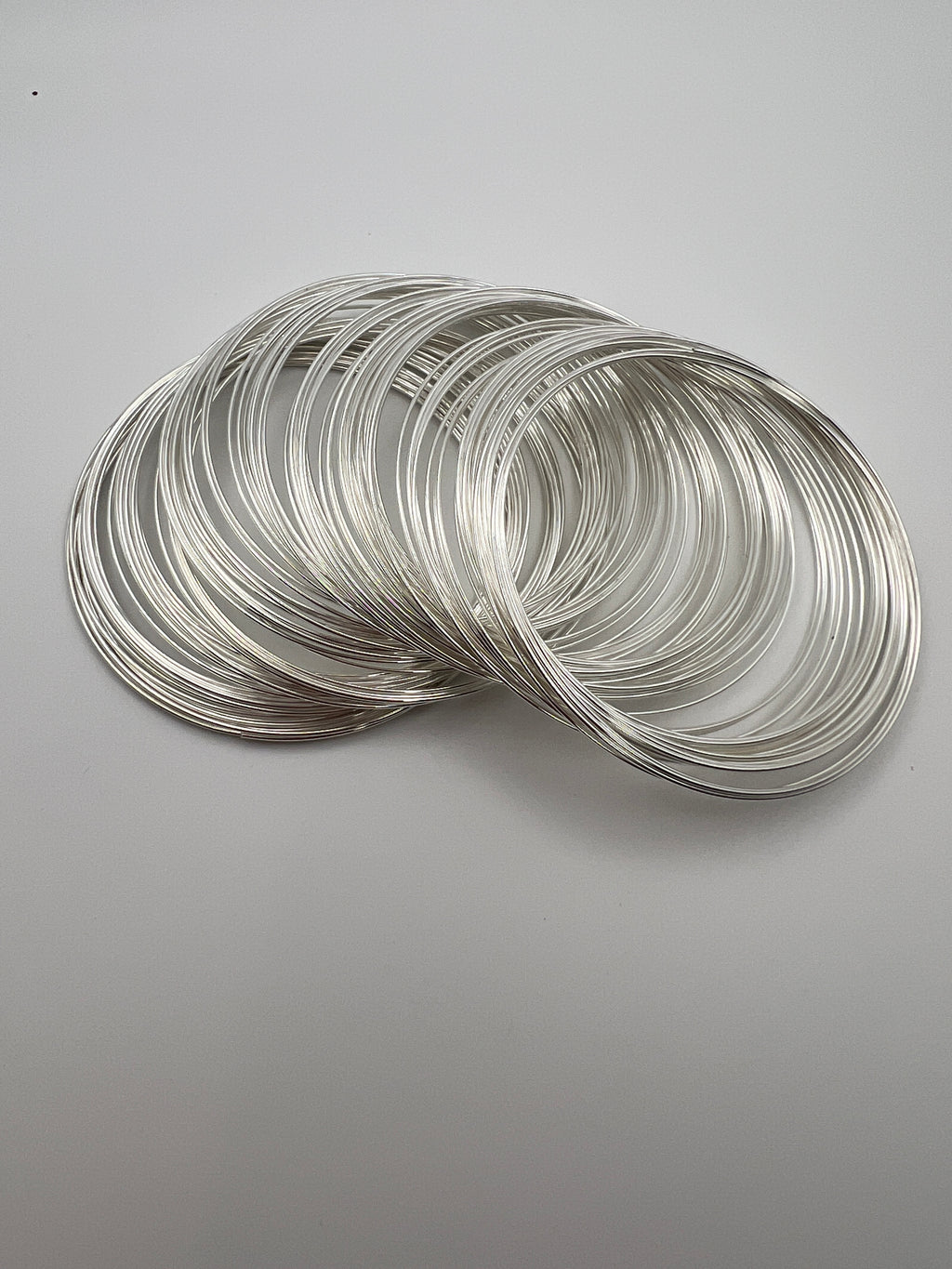100 loops of silver carbon steel memory wire for bracelet making, 0.6mm thickness.